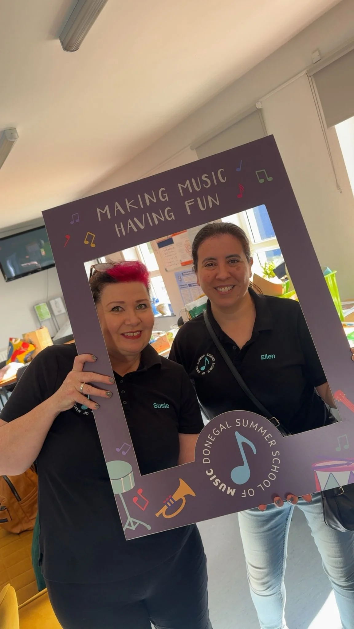 Volunteers posing with the DSSM Making Music Having Fun photo frame