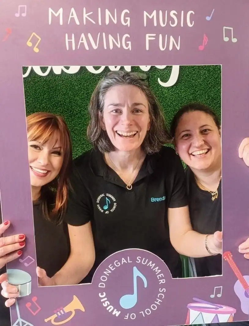 Staff and instructors posing with frame